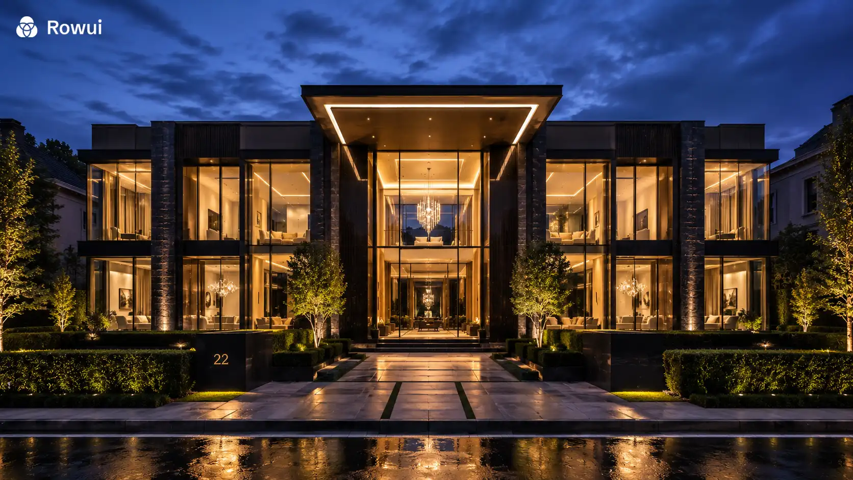 Modern concrete and glass villa at dusk with a reflecting pool